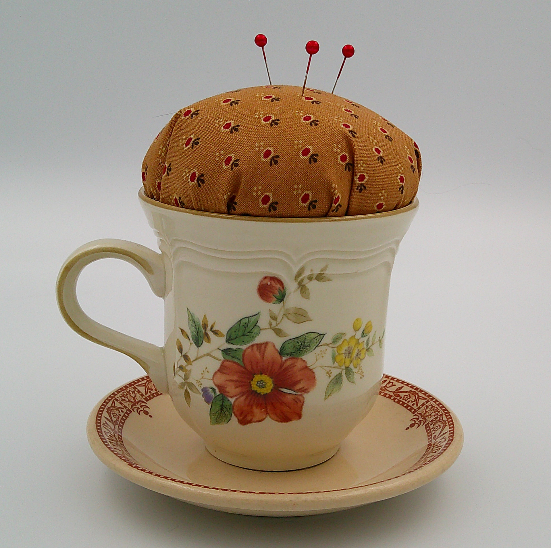This is the backside of the teacup pincushion and shows the different flowers as well as the details of the fabric used. This is the backside of the teacup pincushion and shows the different flowers as well as the details of the fabric used.